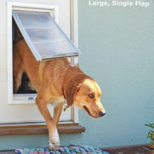 A dog goes through a large dog door.
