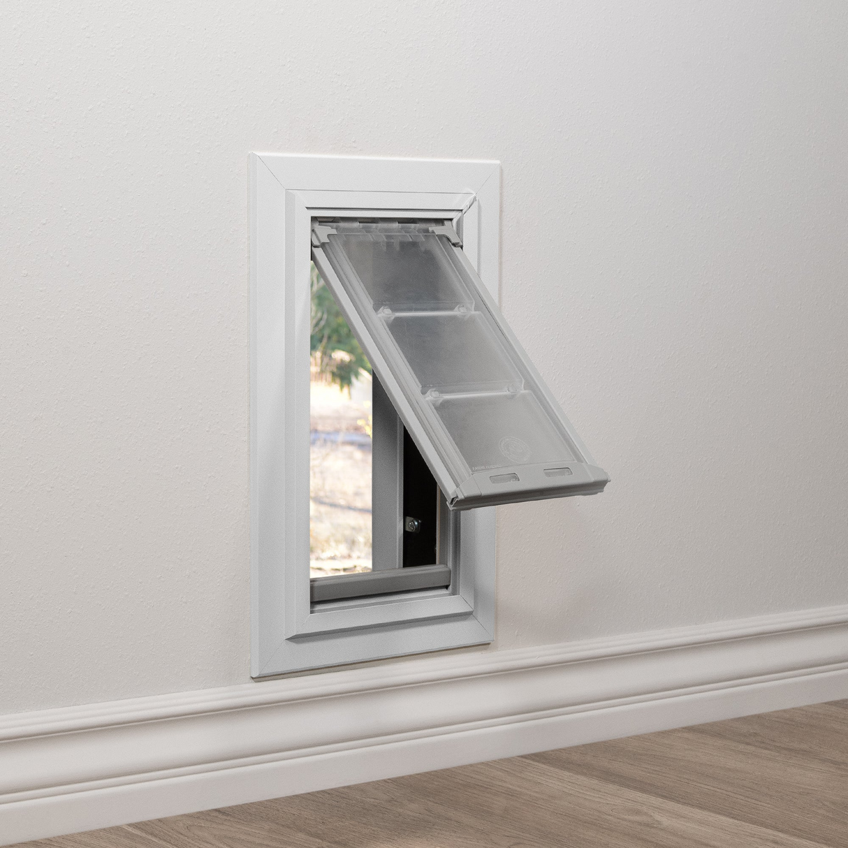 A pet door is installed in a wall.