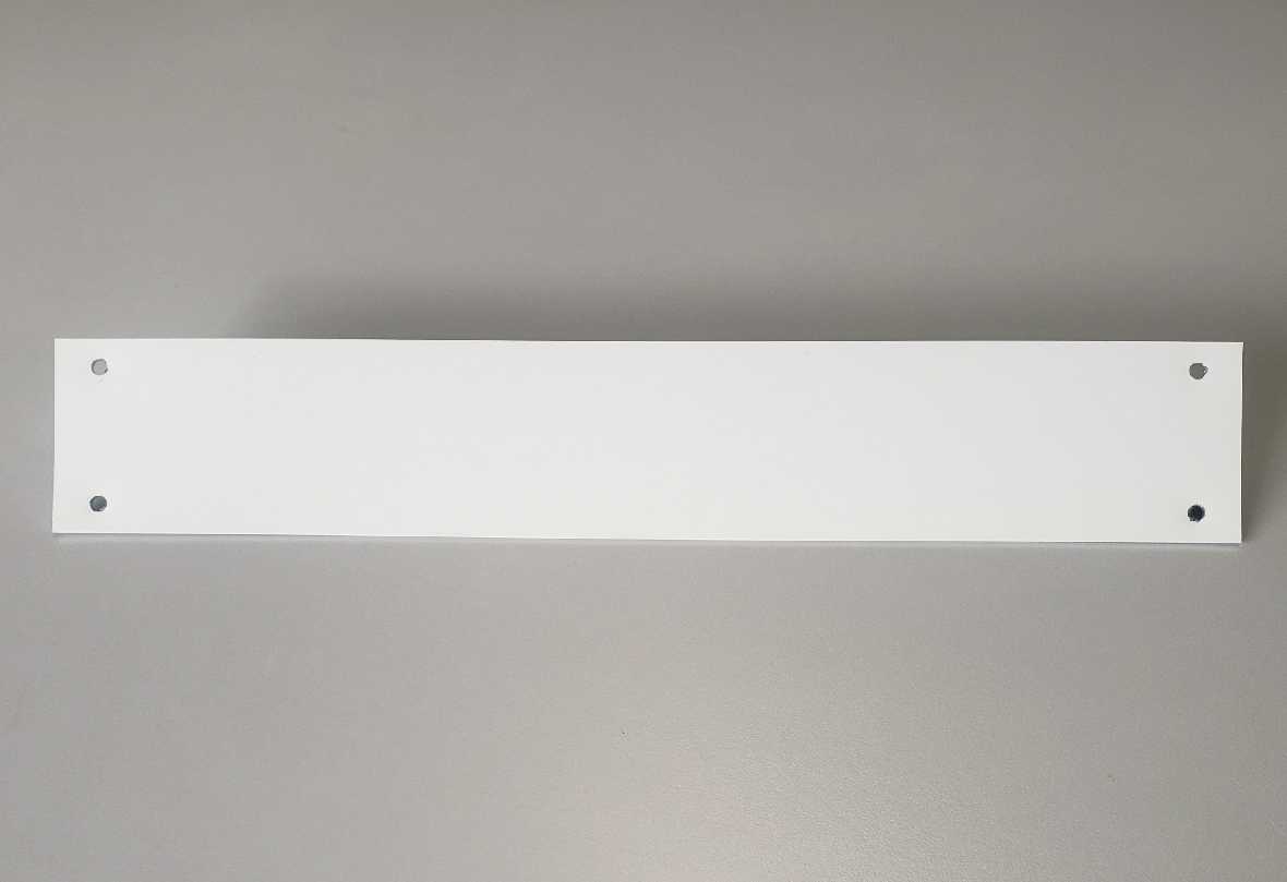 A white rectangular board with four holes is centered on a gray background.