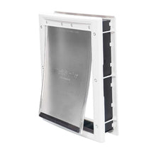A PetSafe pet door with a flexible flap and white frame.