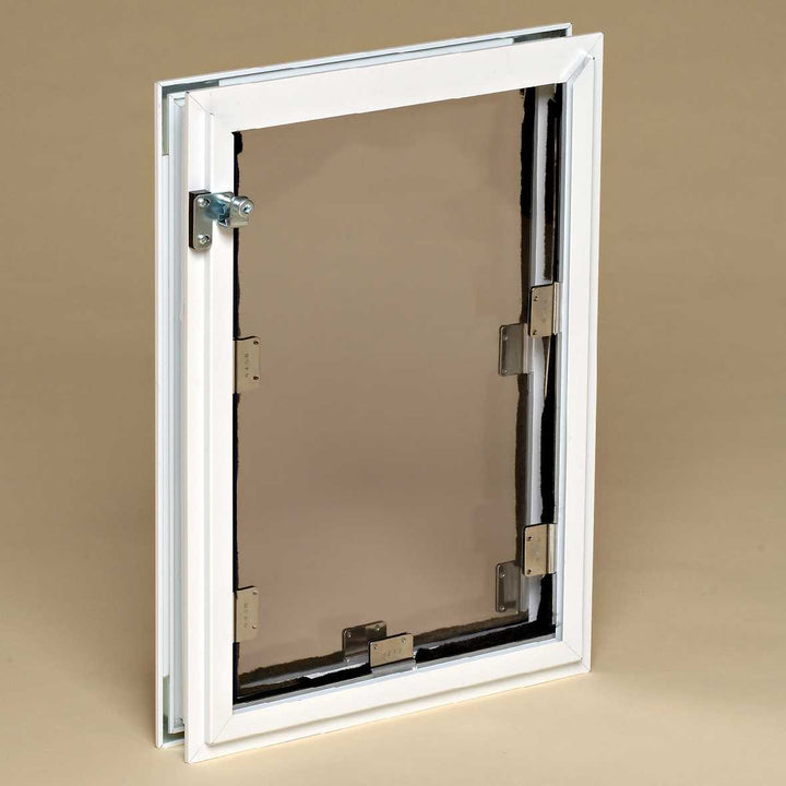 A white framed pet door with a tinted flap and metal hardware.