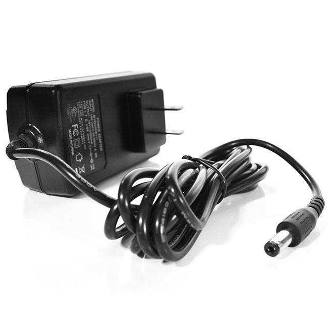 A black power adapter with a coiled cord and barrel plug.