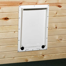 A white pet door is installed in a wood plank wall.