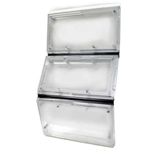 Three stacked, clear plastic electrical enclosures are connected by black bands.