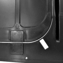 Close-up of a black textured surface with a white line and a small white sticker.