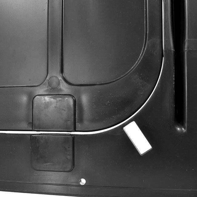 Close-up of a black textured surface with a white line and a small white sticker.