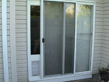 Exterior view of a sliding glass door with a built-in pet door.