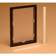 A framed clear pet door and two white cylindrical objects are displayed.