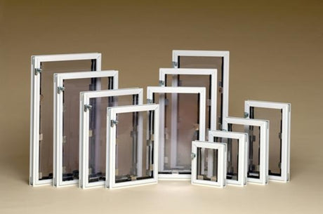 A collection of white-framed window screens in varying sizes.