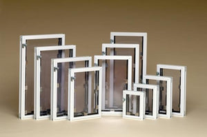 A collection of white-framed window screens in varying sizes.