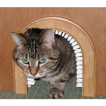 A cat doing through the Cathole cat door, which has dettachable brushes that remove shedding fur. 