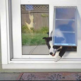 A black and white dog is halfway through a pet door installed in a sliding glass door.