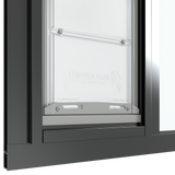 The bottom section of the black Thermo Sash 3e pet door for sash window is shown closed in a sash window