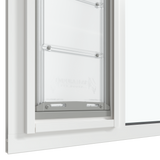 The bottom section of the white Thermo Sash 3e window sash cat door is shown closed within a sash window, highlighting the seal