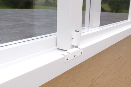 Close-up of a white sliding glass door track with hardware.
