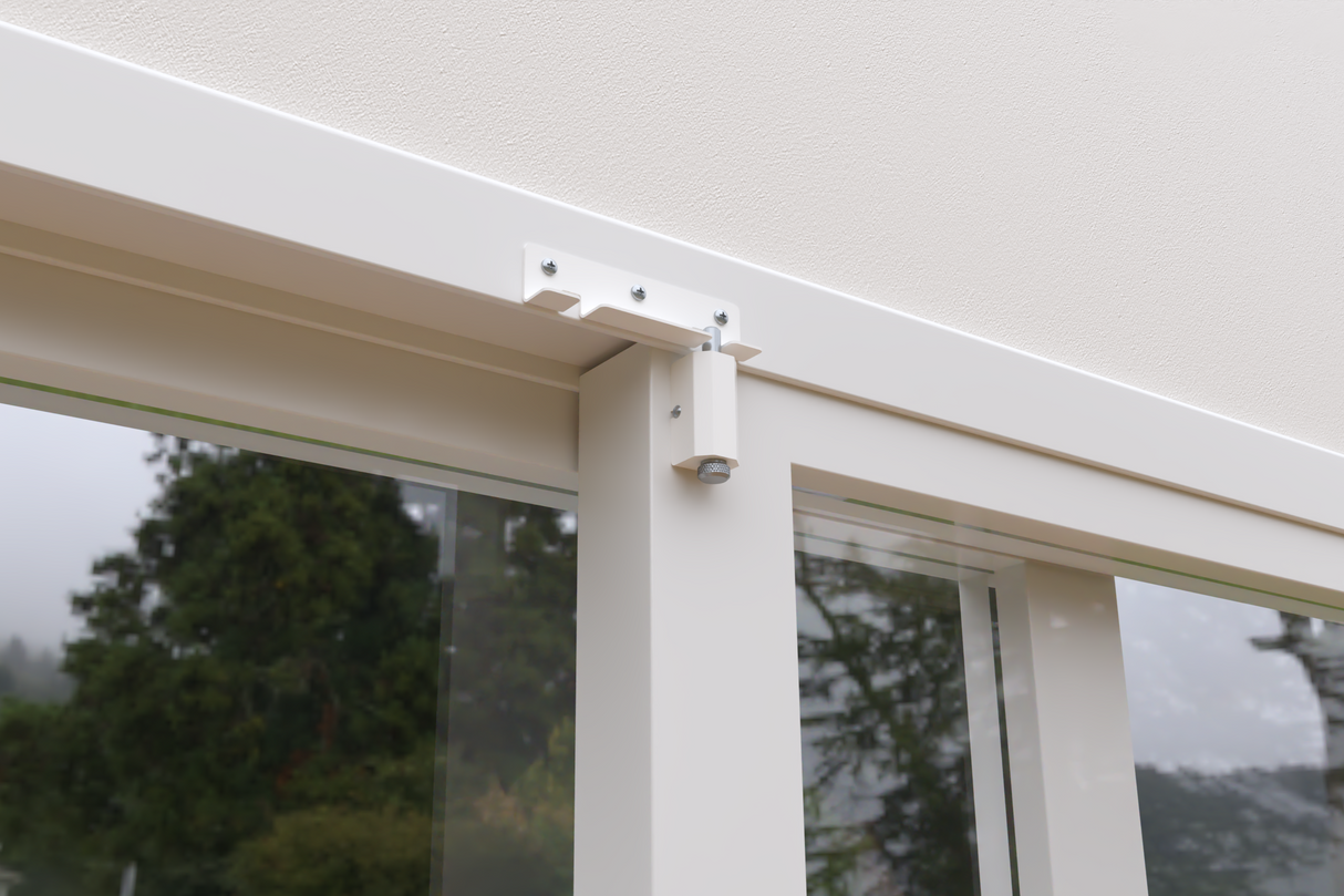 Close up of a white-framed window with a mounting bracket and bolt.