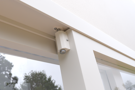 Close up of a white frame with a mechanism attached.