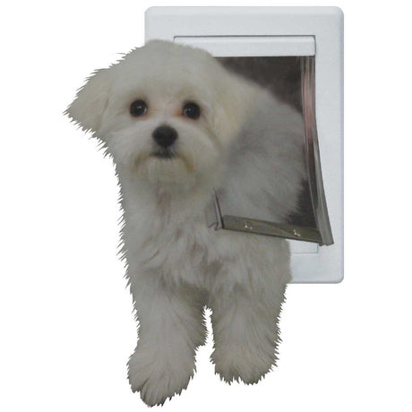 A white fluffy dog partially through a white dog door.