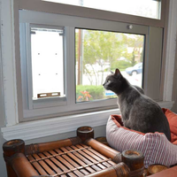 cat sitting in front of endura flap sash window panel pet door 