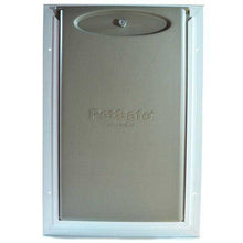 A PetSafe pet door with a white frame.