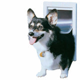 A tri-color corgi dog passes through a white-framed dog door.