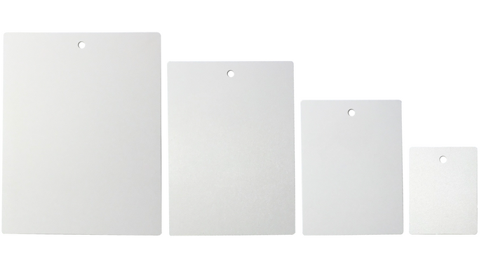 Four blank white tags of varying sizes with a hole at the top, arranged from largest to smallest.