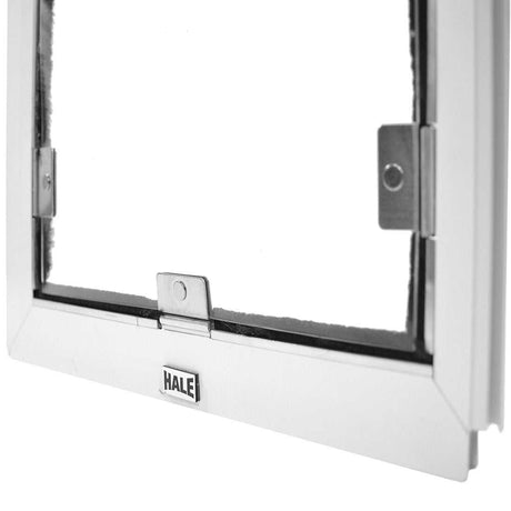 Close up of a white Hale brand dog door frame with metal hardware.