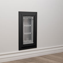 A pet door is installed in a wall.
