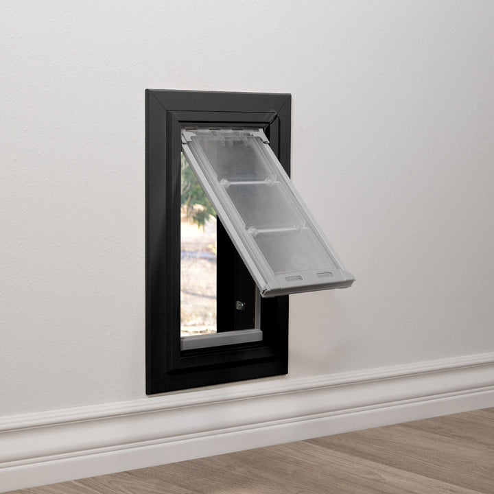 A pet door is installed in a wall.