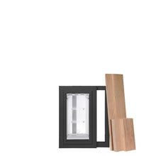 A dog door with black frame and clear flaps sits next to a stack of wooden planks.