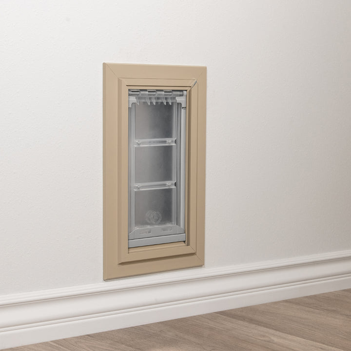 A dog door is installed in a white wall near the baseboard.