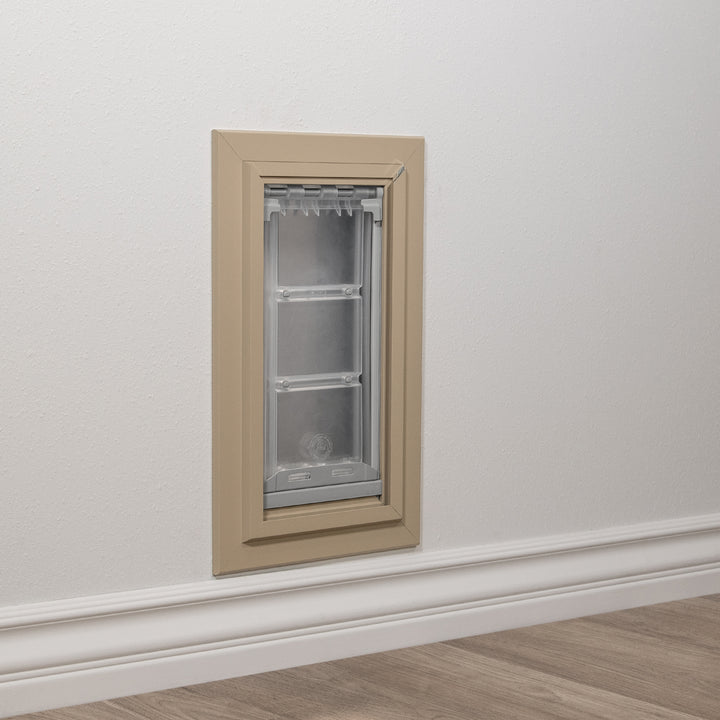 A pet door is installed in a wall.
