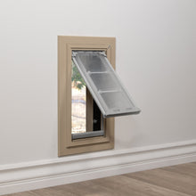 Pet door installed in a wall, flap ajar.
