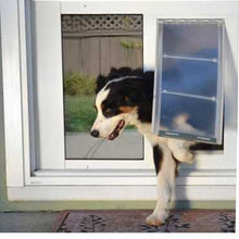 A dog is halfway through a dog door in a white sliding glass door.