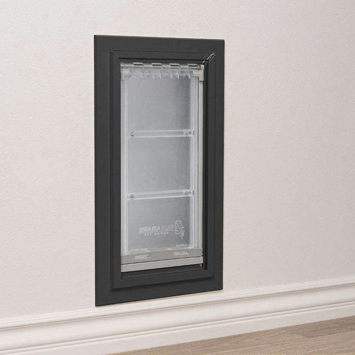 An Endura Flap pet door installed in a wall.