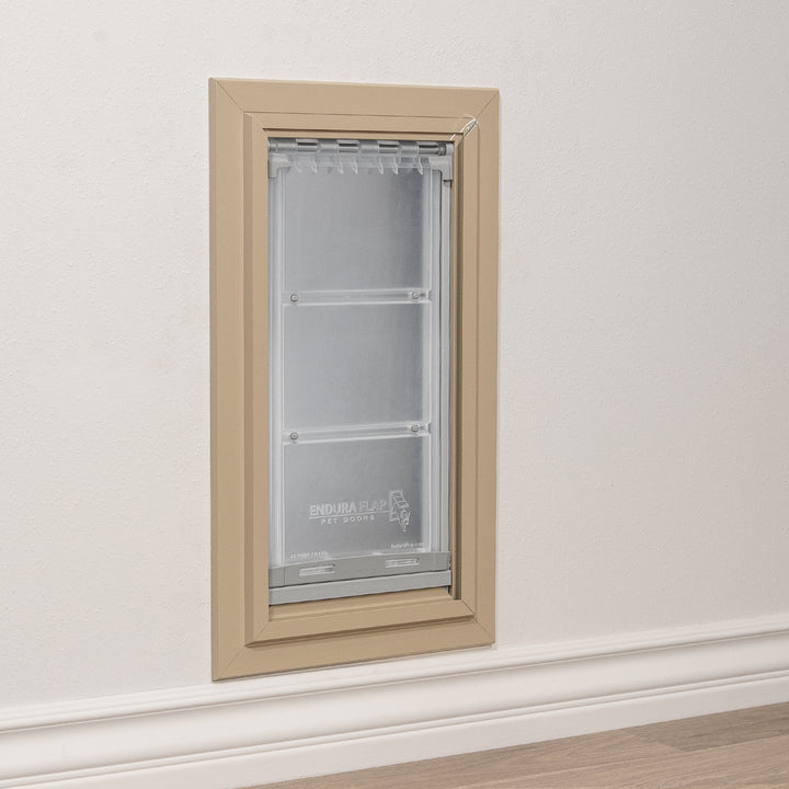 A pet door by Endura Flap is installed in a wall.