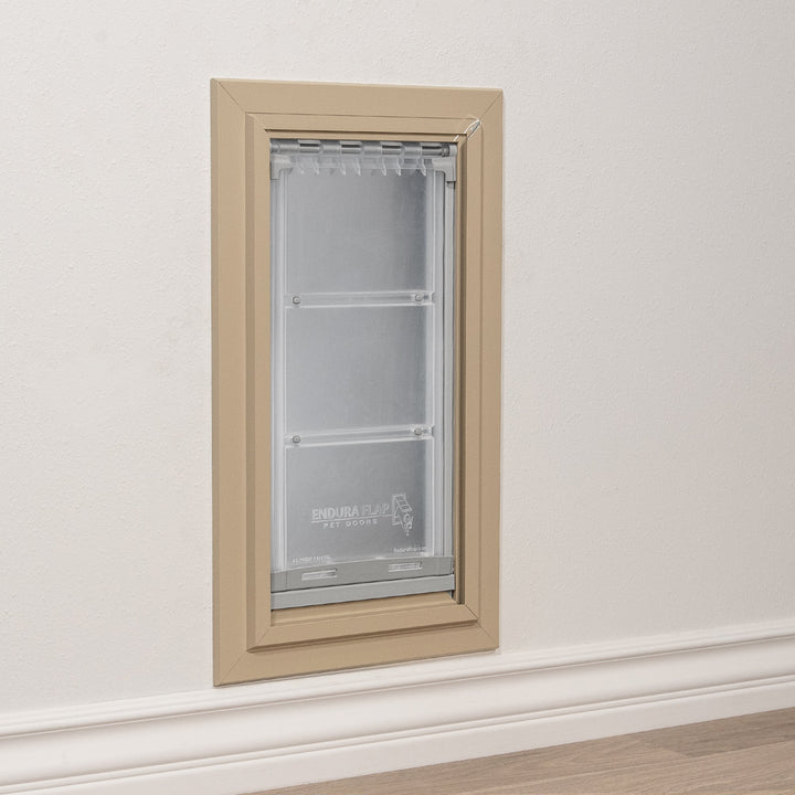 A pet door installed in a wall.