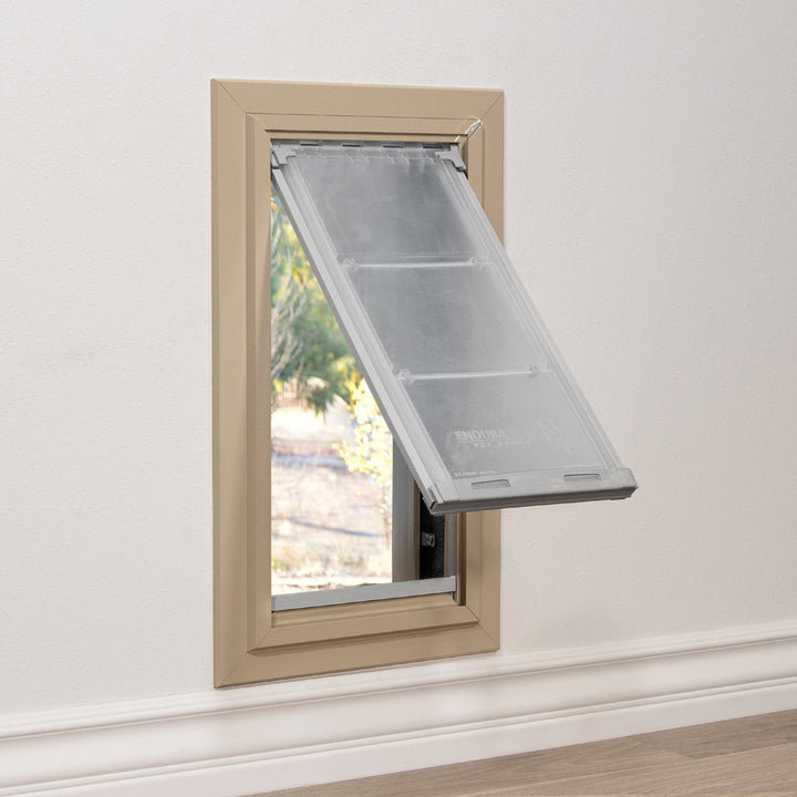 A pet door is installed in a wall.