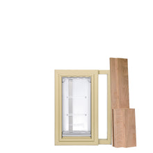 Tan window frame with a pet door and wood filler pieces.