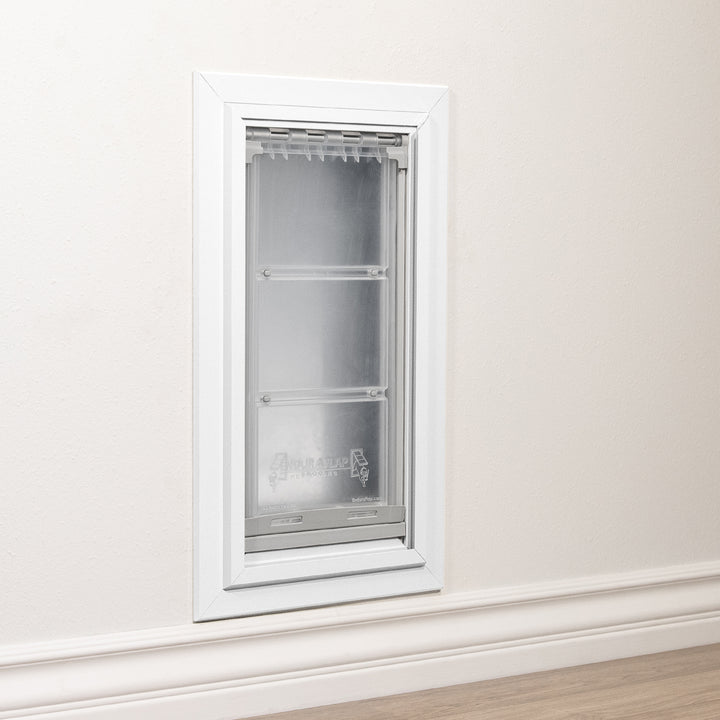 A pet door is installed in a wall.