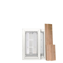 Two white framed pet doors next to several wooden boards.