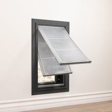 A gray-framed pet door with two partially opened clear flaps is installed in a white wall.