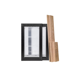 Two black-framed, clear-paneled pet doors are adjacent to a stack of wooden panels.