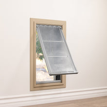 A pet door with a partially open transparent flap is installed in a wall.