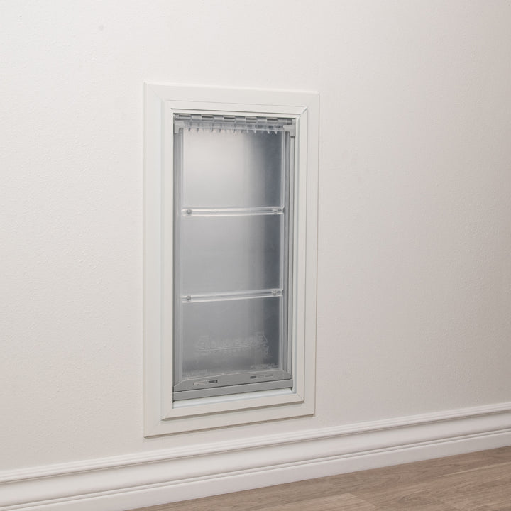 A pet door is installed in a wall.