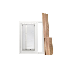A pet door is installed in a white window frame, next to three planks of wood.