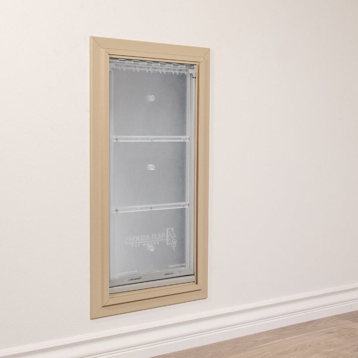 A pet door is installed in a wall.