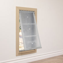 A pet door with a partially open flap is installed in a wall.