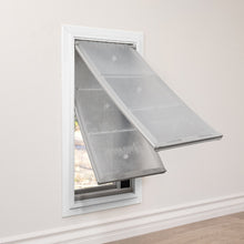 A white framed Endura Flap pet door with two transparent flaps installed in a wall.