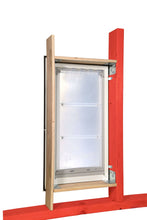 A white-framed pet door with a clear flap is mounted in a wooden structure with red and natural wood beams.